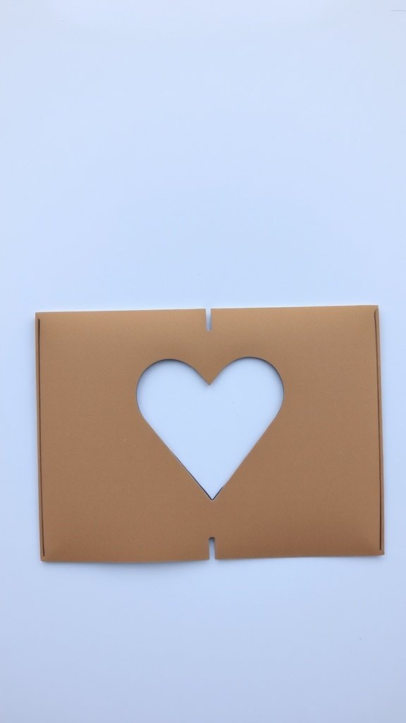 A cardboard cutout card featuring a heart shape in the center.